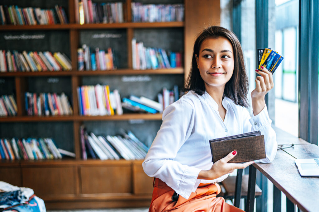 Postgraduate student studying in a library with books and learning materials