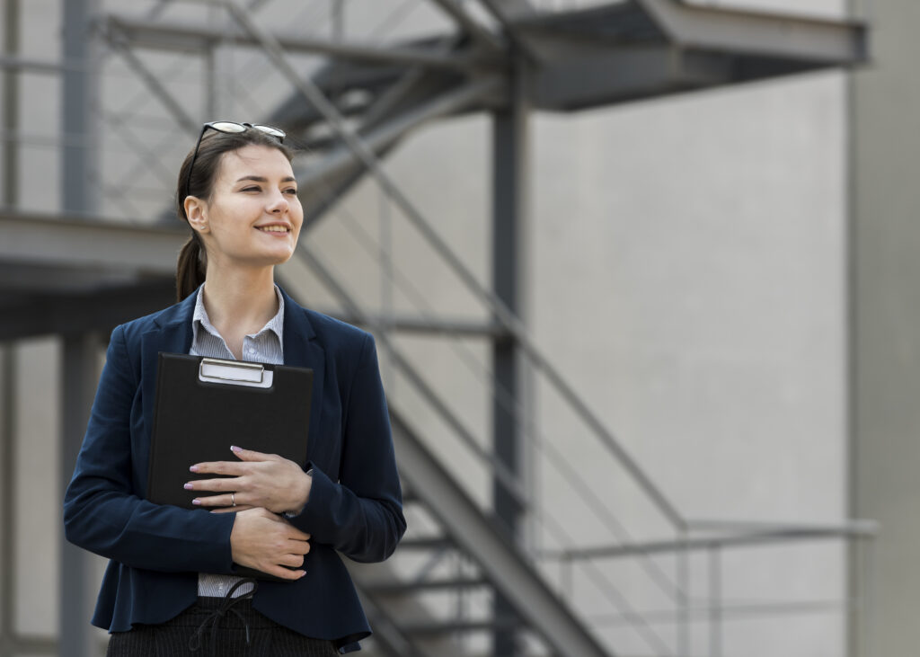 Confident female student holding documents, representing higher education and career-focused learning